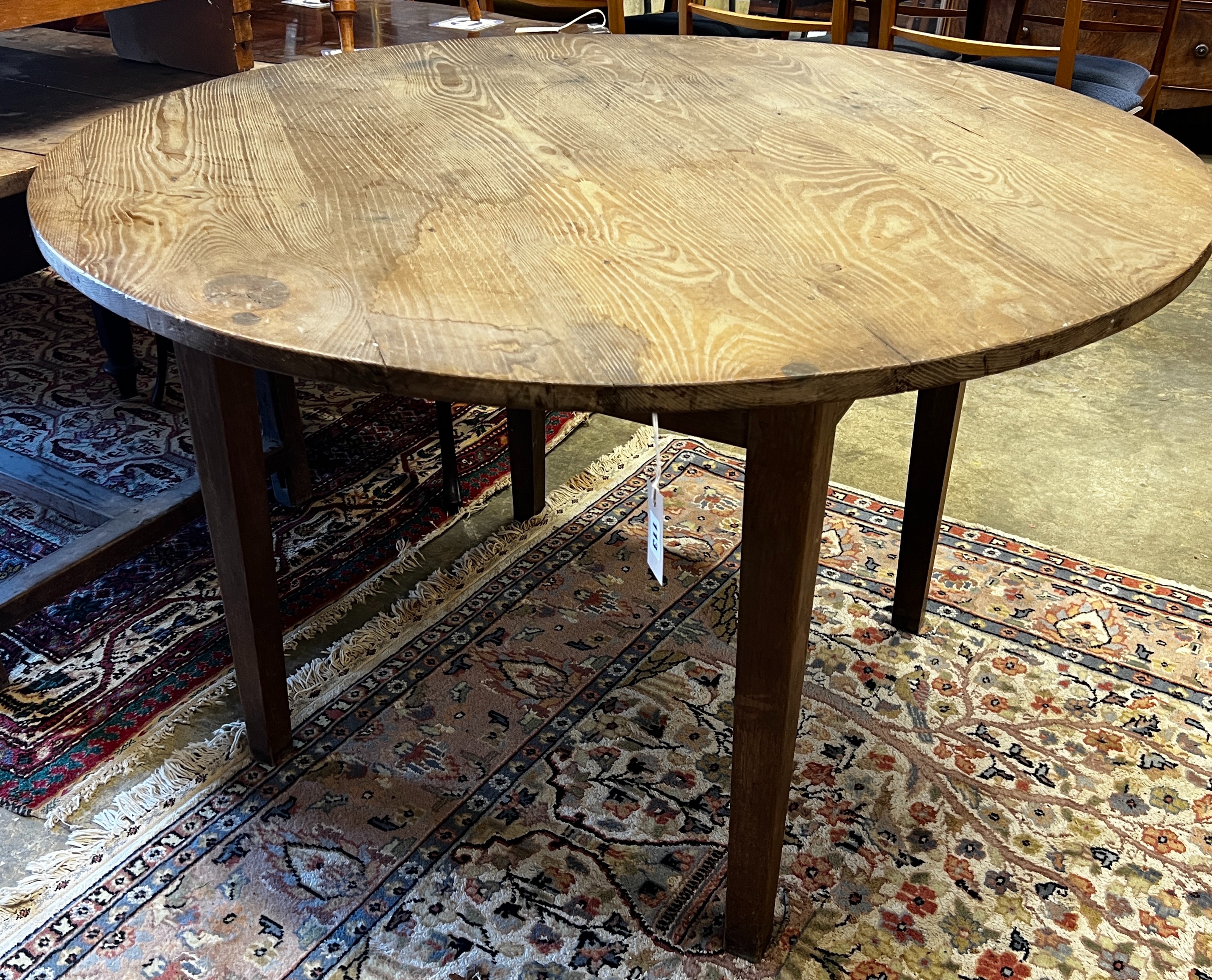 A 19th century French circular pine and oak kitchen table, diameter 116cm, height 74cm